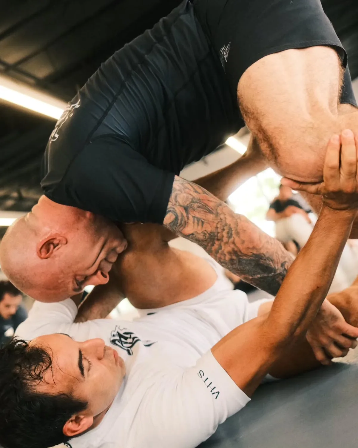 Two adult students working through a close No-Gi position at Phantom