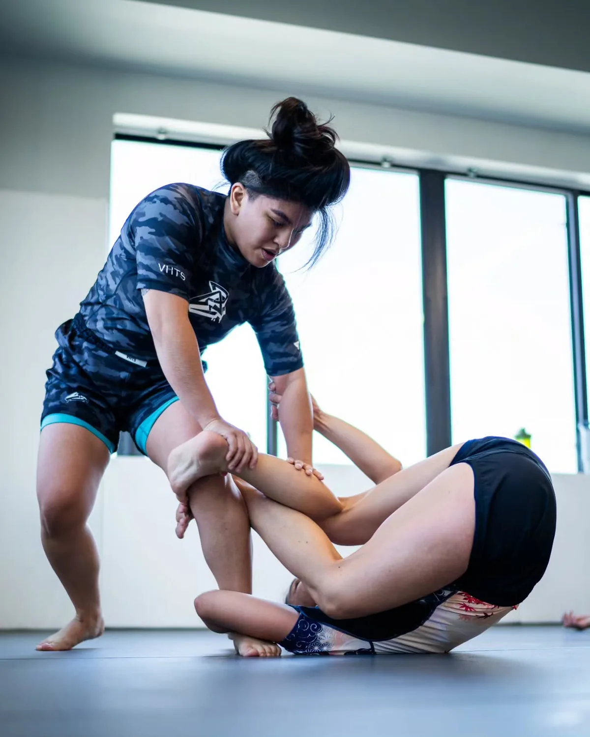 Two adult students working through a No-Gi guard position at Phantom